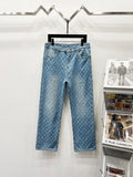 Light blue monogram denim pants with button fly and belt loops