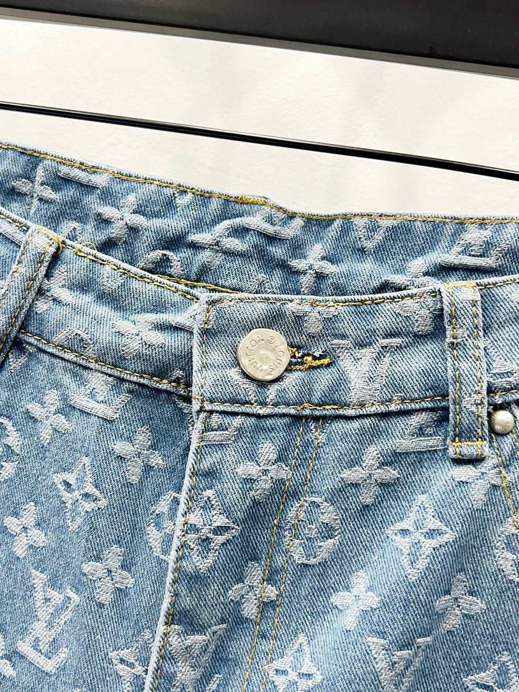 Light blue monogram denim waistband with button and zip fly detail