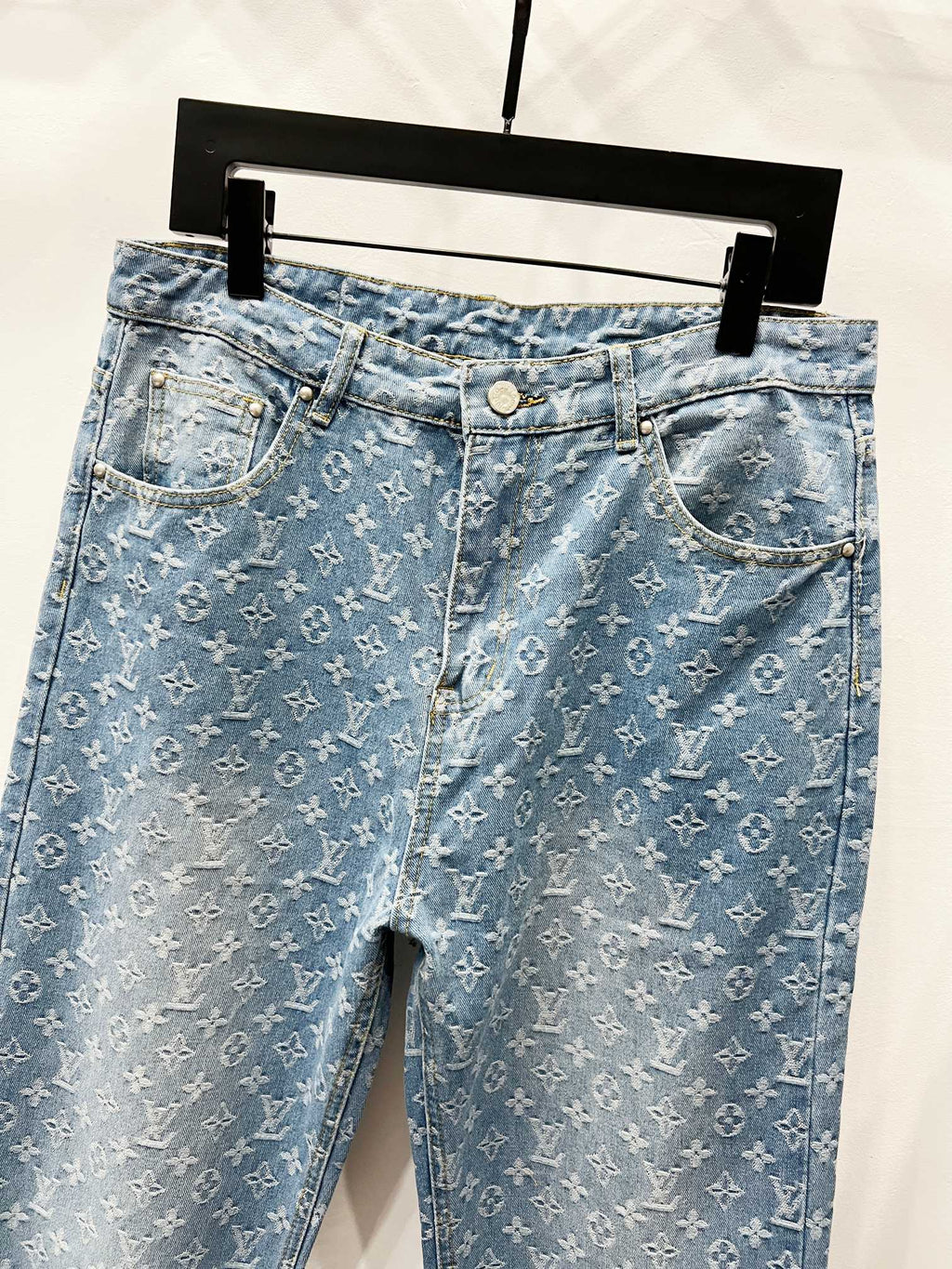 Light blue monogram denim jeans with front pockets and belt loops