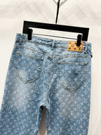 Light blue monogram denim jeans with curved front pockets and button closure