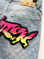 Graffiti patch on light blue monogram denim jeans pocket area