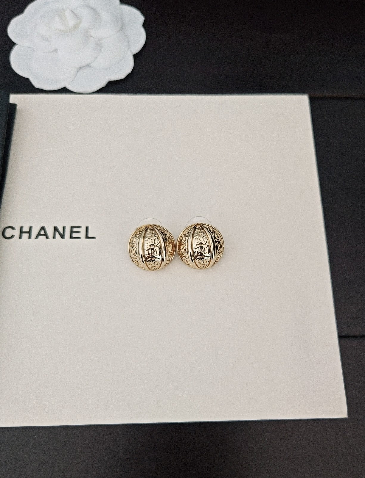 Round gold-tone stud earrings in gift box, two side by side