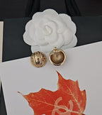 Round gold-tone stud earrings, one textured back and one medallion