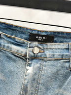 Light blue denim jeans waistband with AMIRI label and button closure