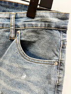 Light blue denim jeans front pocket with metal button and stitched waistband