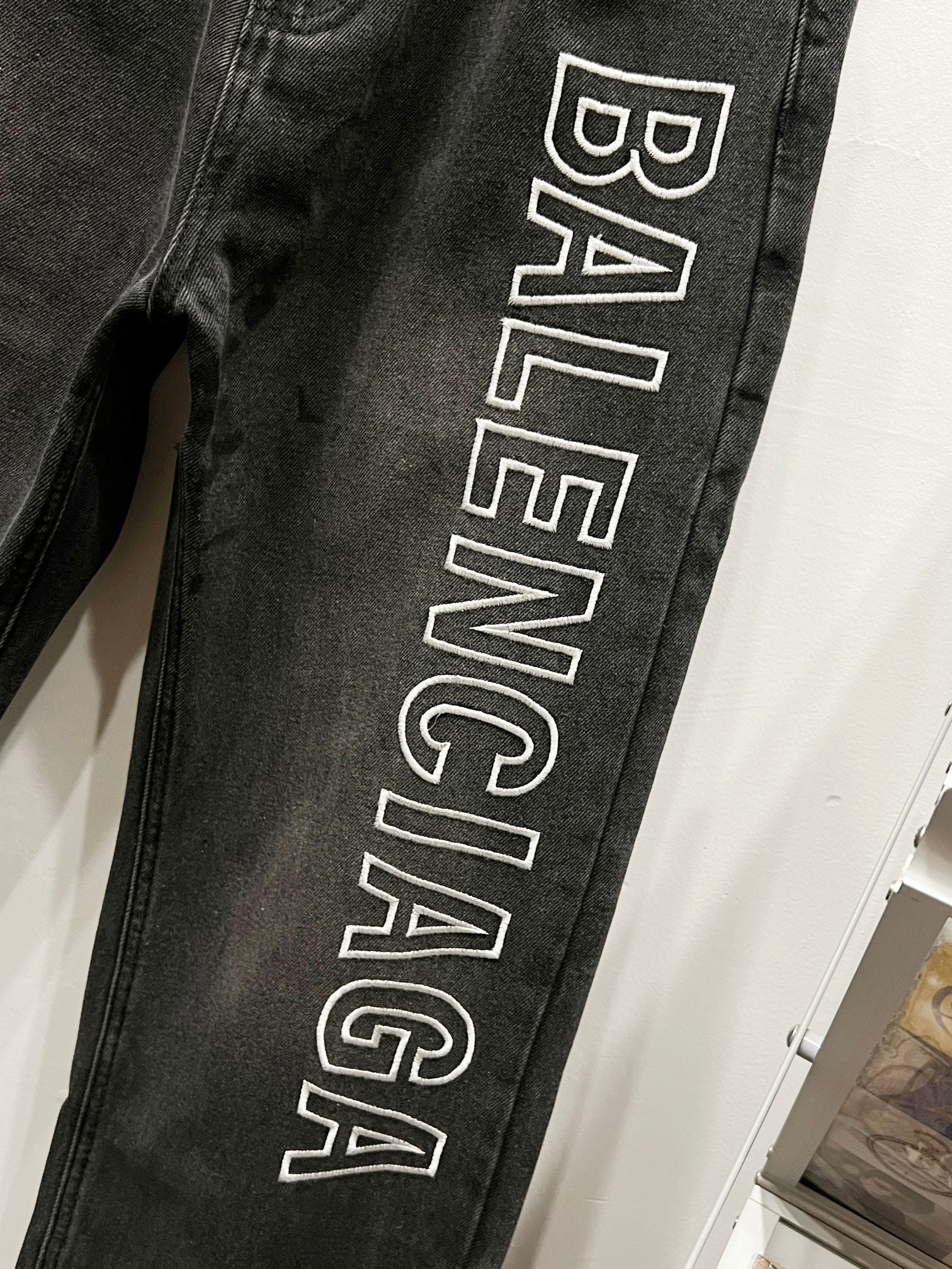Dark denim pant leg with large Balenciaga logo print
