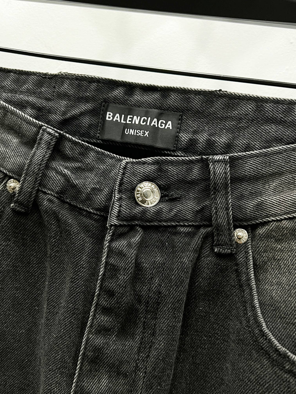 Dark denim waistband with Balenciaga Unisex label and metal button closure