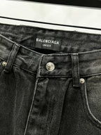 Dark denim waistband with Balenciaga Unisex label and metal button closure