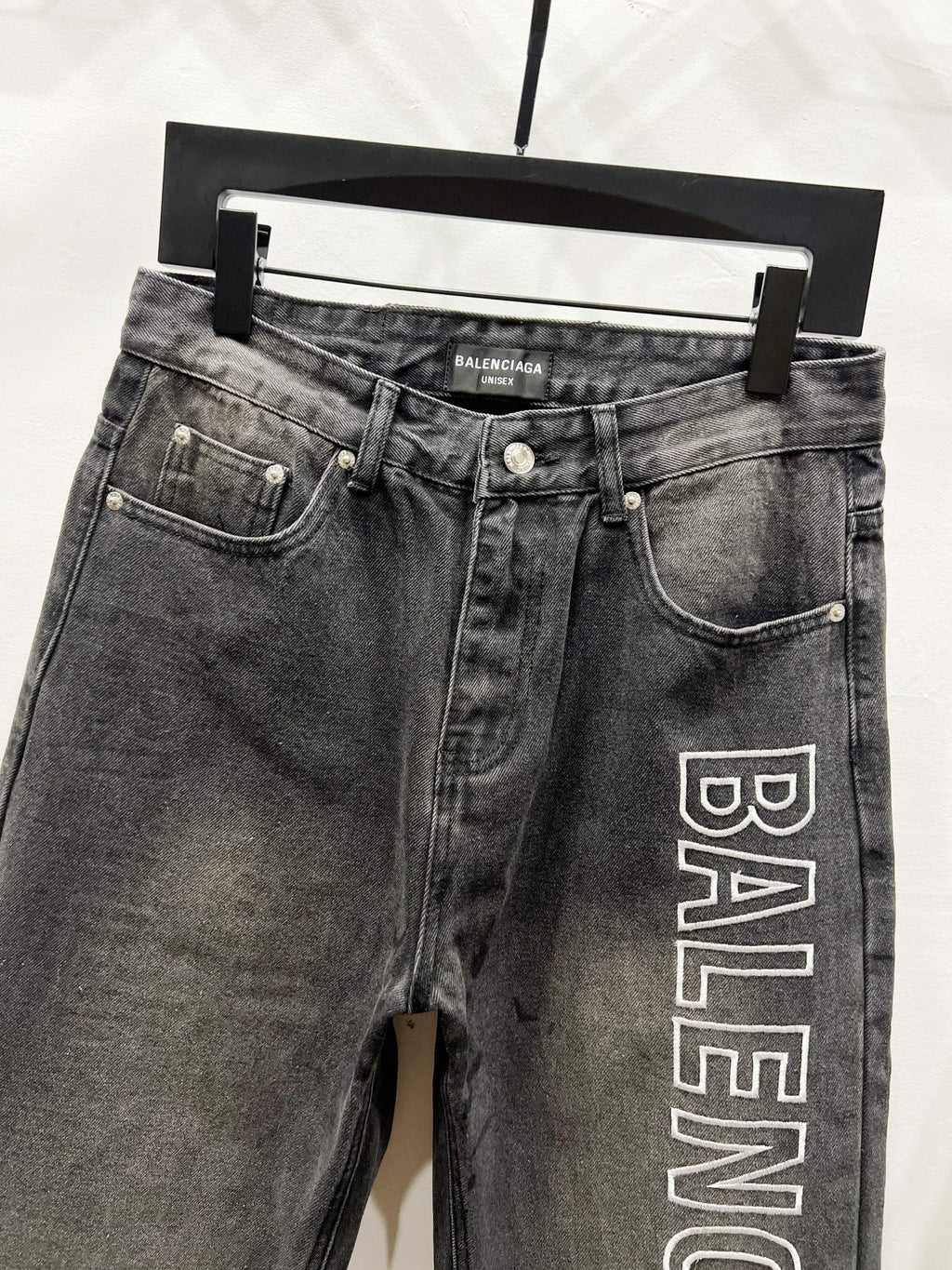 Dark denim pants with side pockets and Balenciaga logo print on right leg