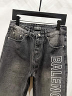Dark denim pants with side pockets and Balenciaga logo print on right leg