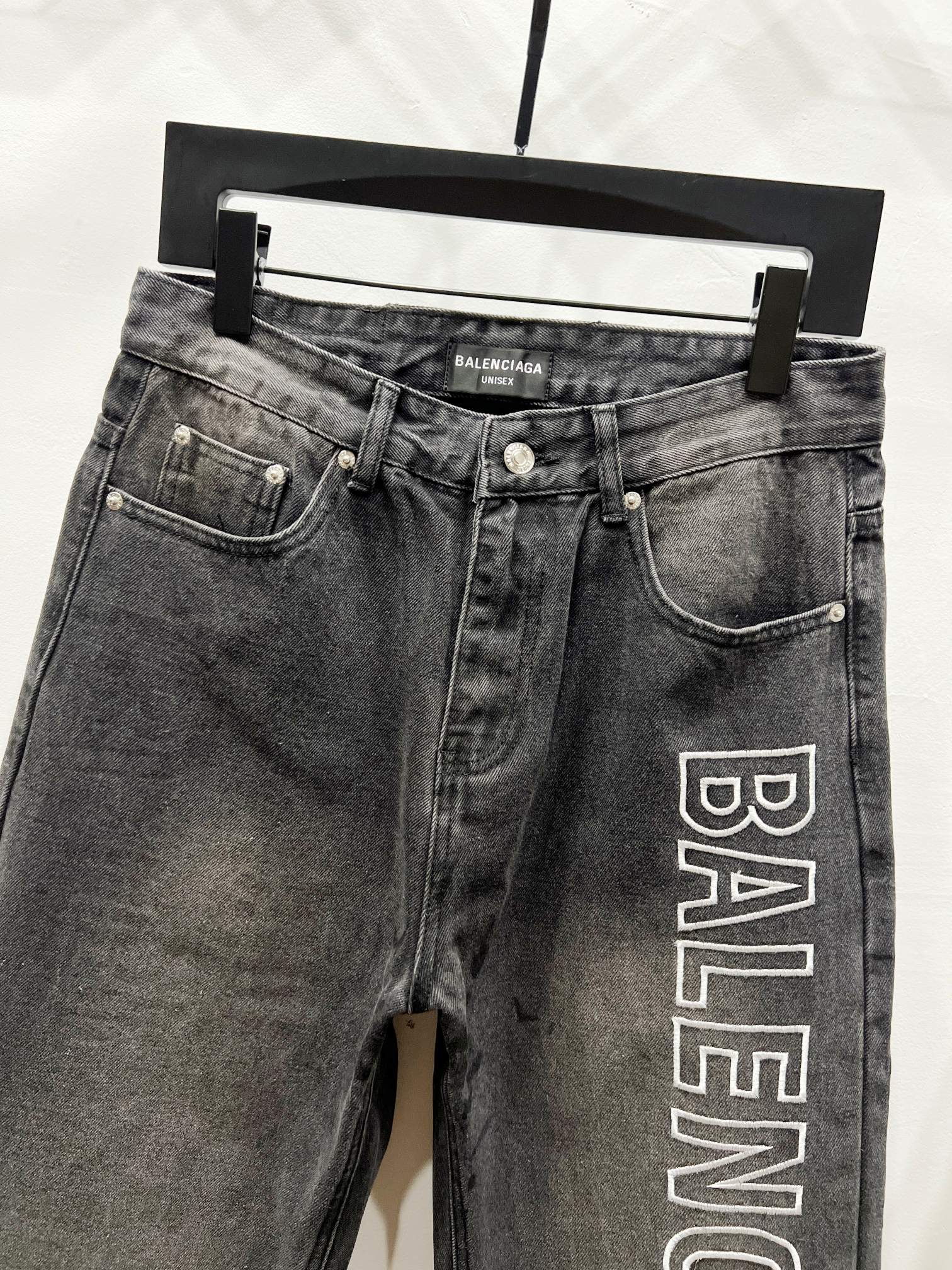 Dark denim pants with side pockets and Balenciaga logo print on right leg