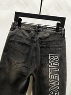 Dark denim pants on hanger with back pockets and Balenciaga logo print