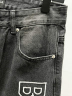 Dark denim front pocket with curved topstitching and Balenciaga logo print