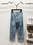 Light blue denim pants with back pockets, belt loops and button fly