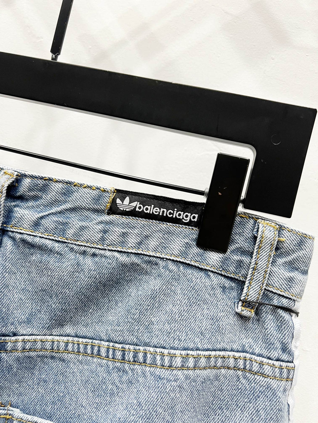Light blue denim waistband with brand logo patch and belt loops