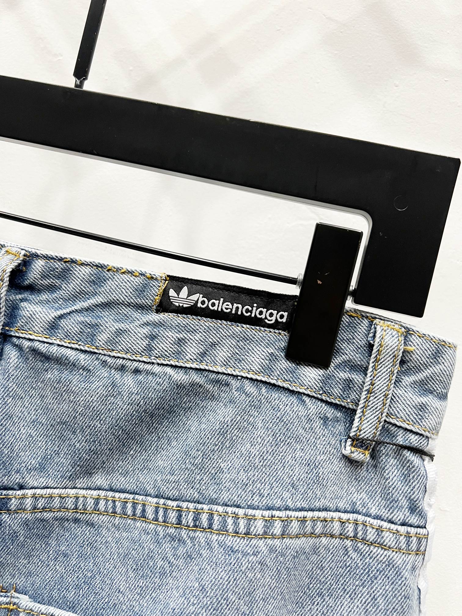 Light blue denim waistband with brand logo patch and belt loops
