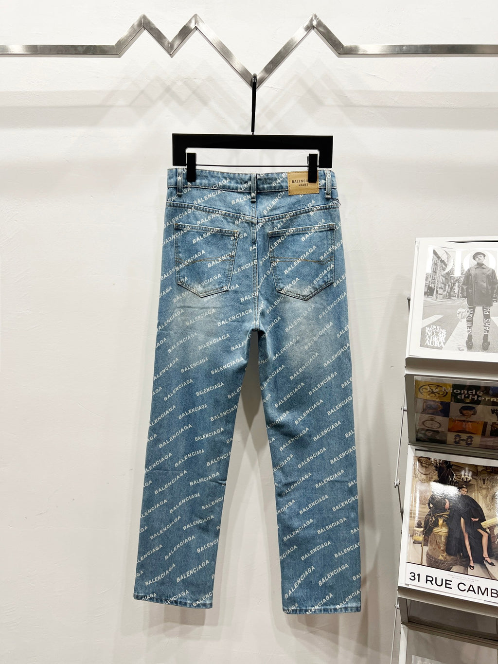 Blue denim pants with all-over logo print, zip fly, front pockets, and belt loops