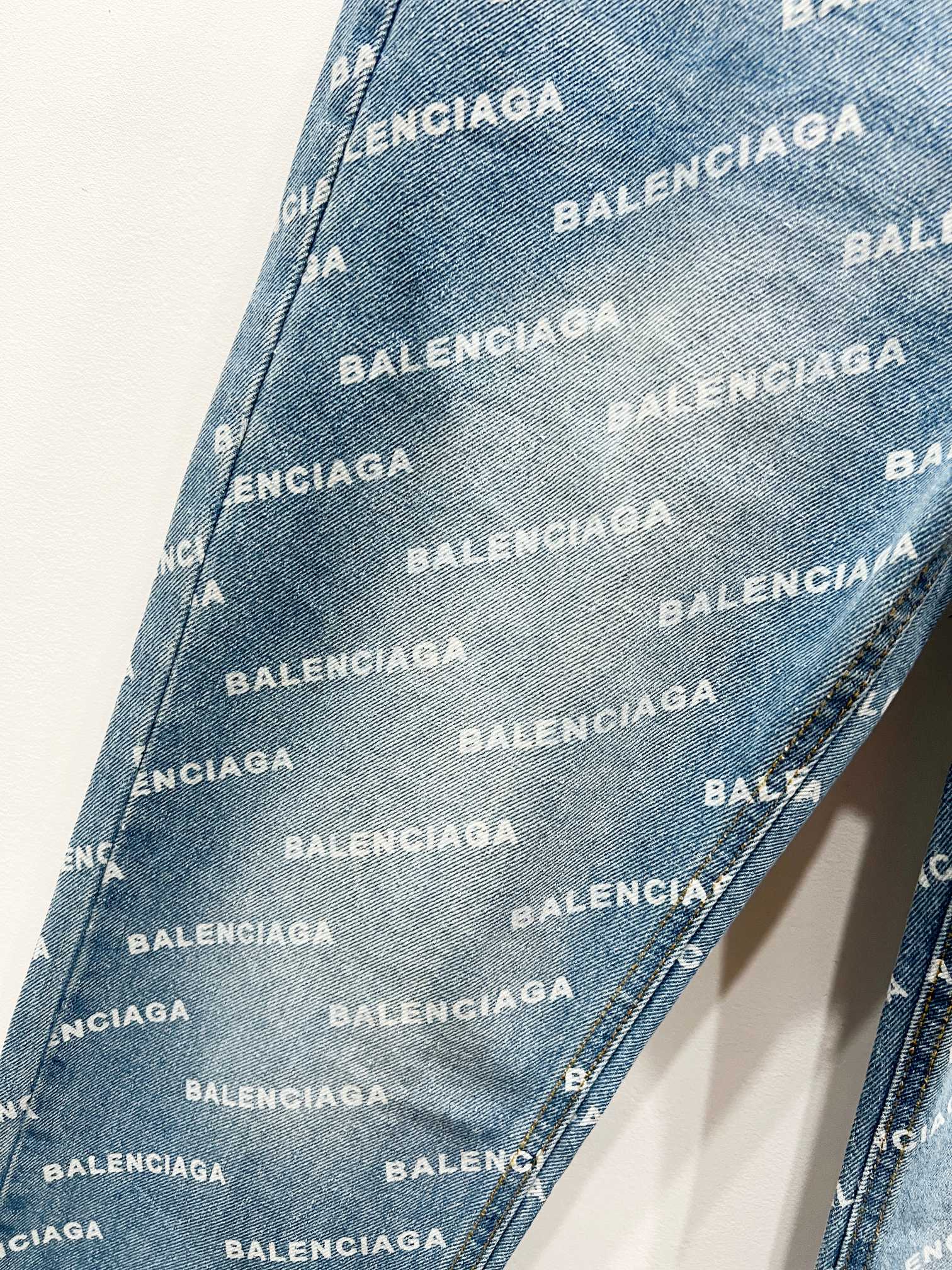 Light blue denim fabric with repeating BALENCIAGA logo pattern, diagonal texture