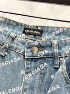Back pocket close-up with BALENCIAGA patch, metal button, and logo printed denim
