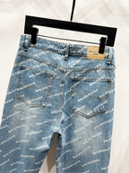Blue logo-print denim pants front view with back darts and patch on waistband