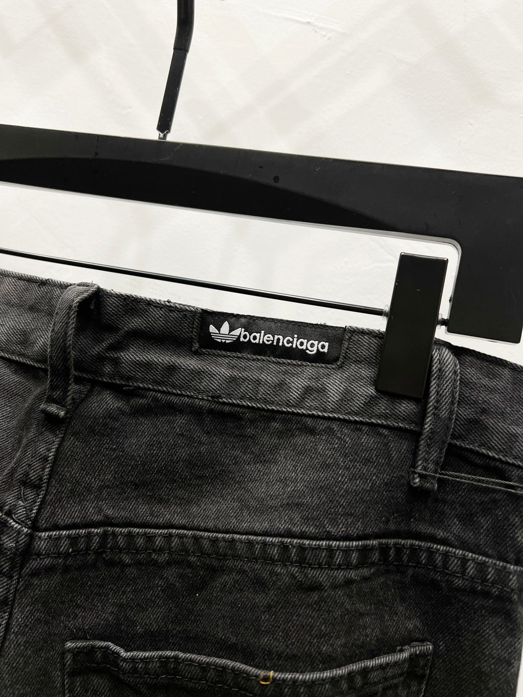 Black denim pants waistband with balenciaga logo patch and belt loops