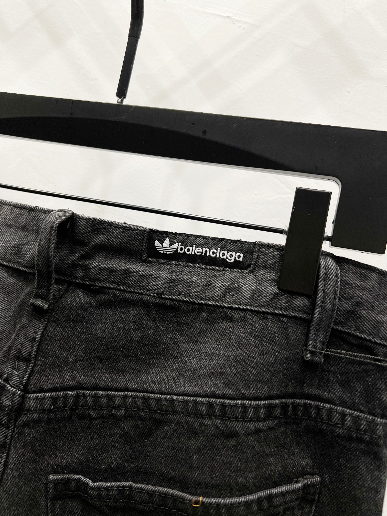 Black denim pants waistband with balenciaga logo patch and belt loops