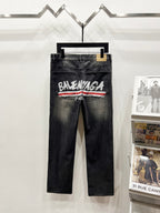 Black denim pants with Balenciaga Paris logo and red stripe, belt loops and button