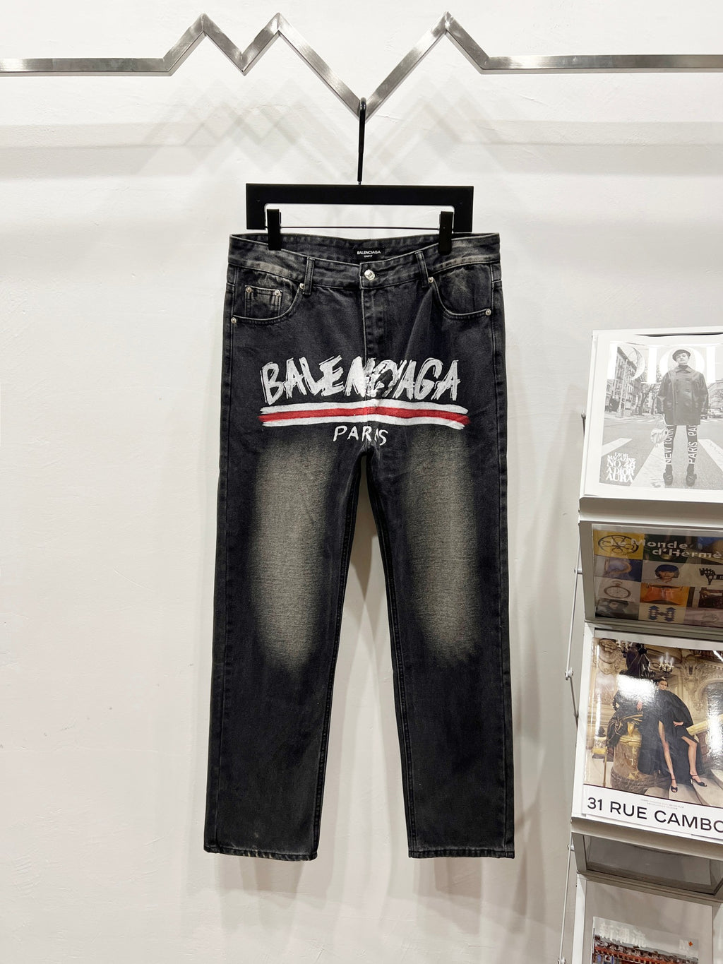 Black denim pants with Balenciaga Paris logo and red stripe across front