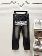 Black denim pants with Balenciaga Paris logo and red stripe across front