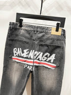 Grey-wash denim pants with Balenciaga Paris logo and red stripe, front close-up