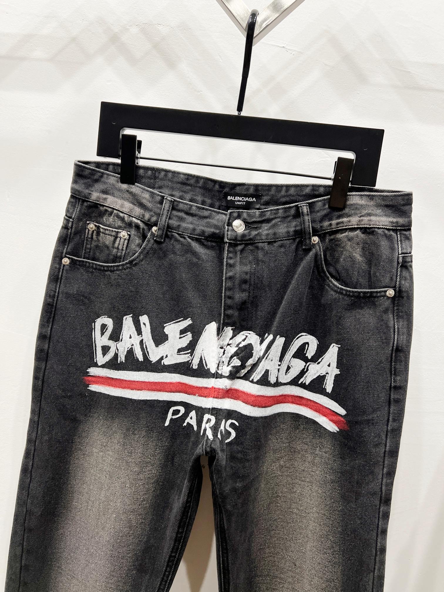 Black denim pants with Balenciaga Paris graphic, button fly, side pockets