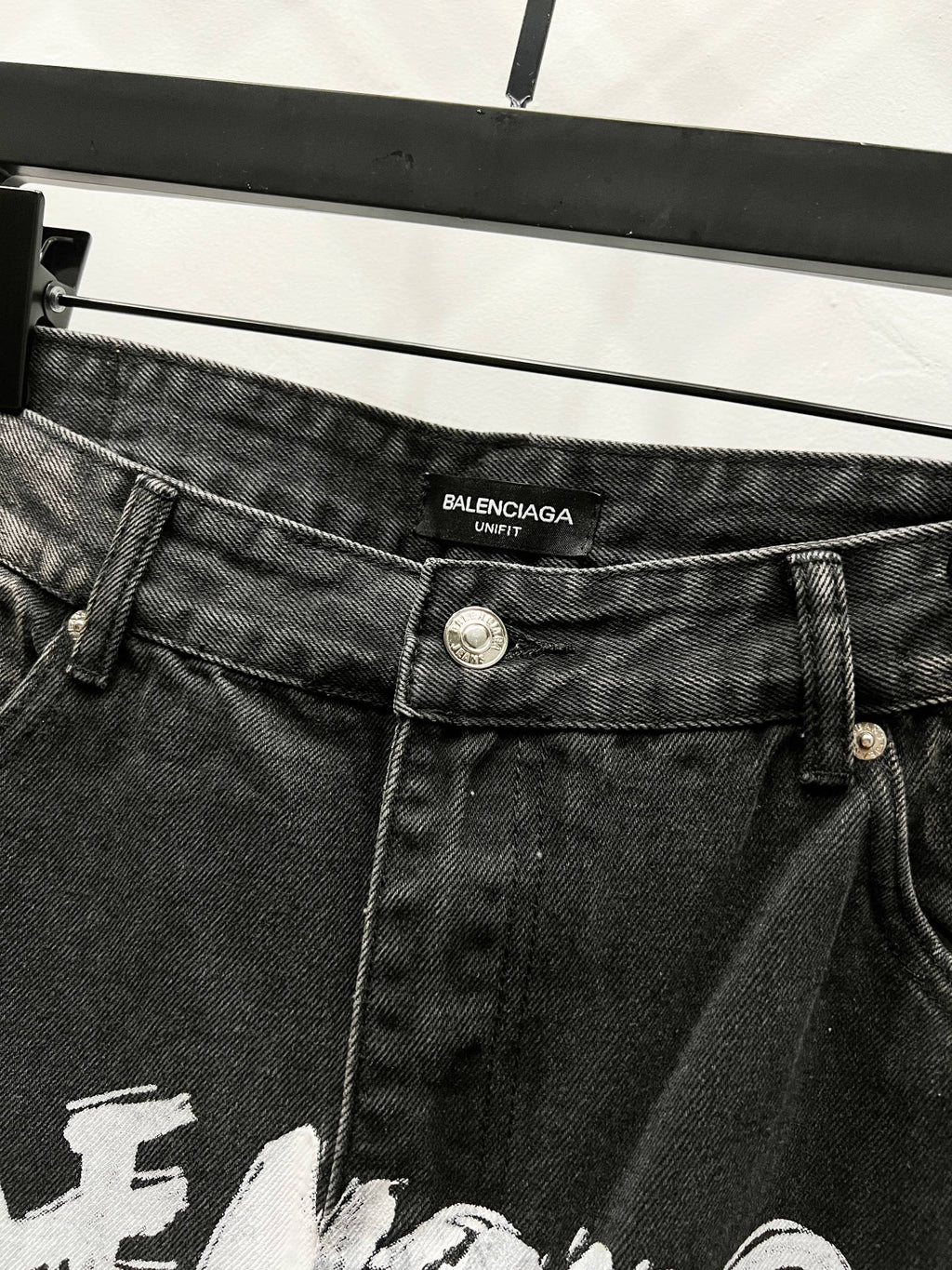 Black denim pants with Balenciaga label on waistband and metal button closure