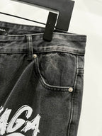 Black denim pants waistband with belt loops, button closure, and front pocket
