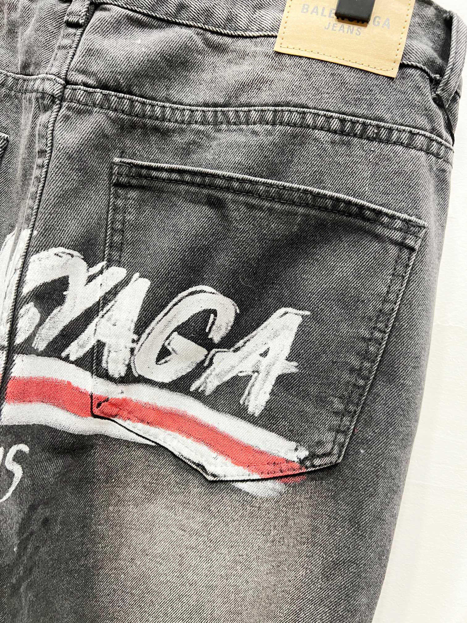 Black denim pants with Balenciaga graphic on thigh and side pocket detail