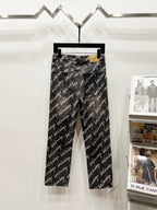Black denim jeans with allover Balenciaga script print, straight-leg front view