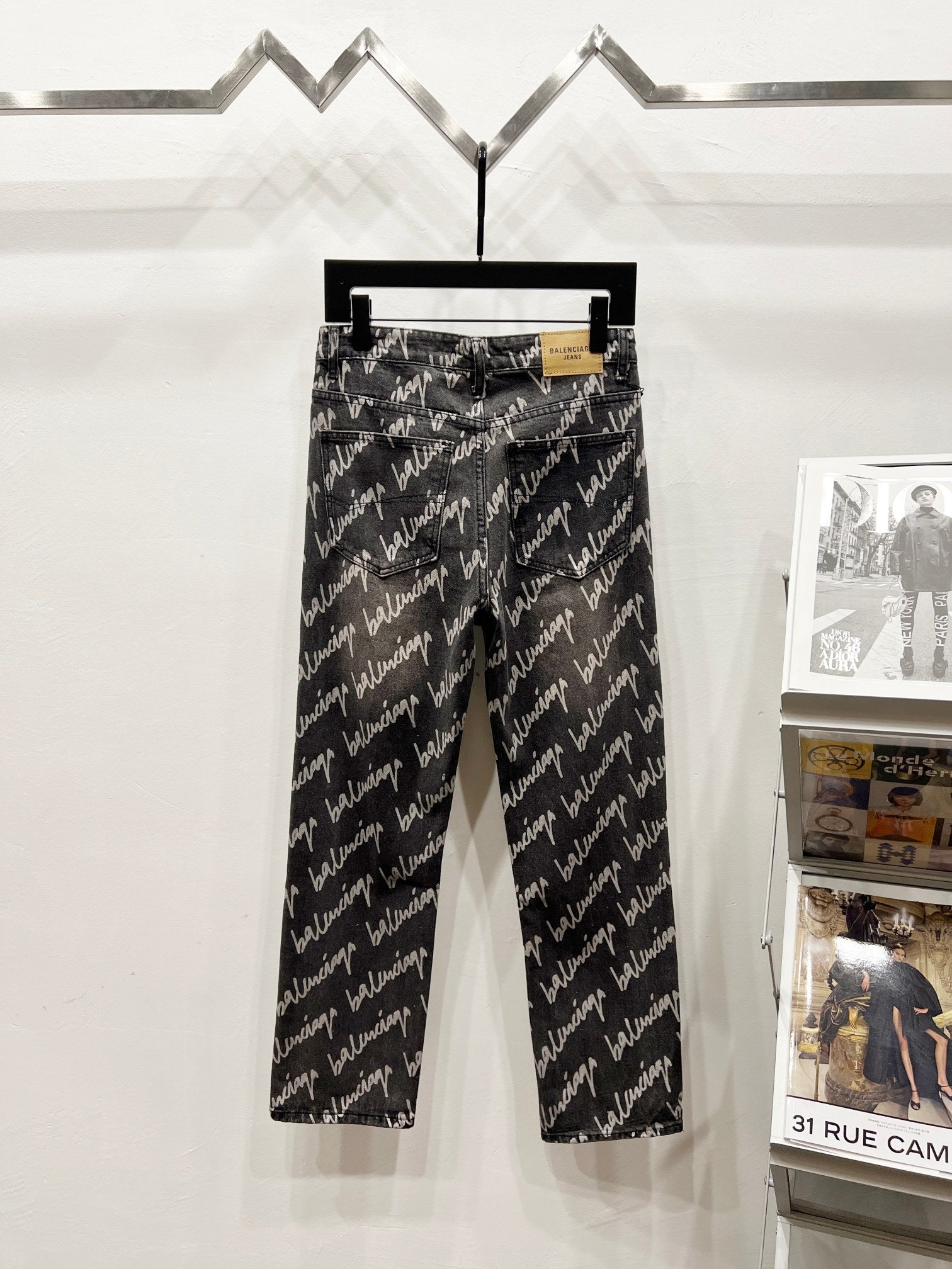 Black denim jeans with allover Balenciaga script print, straight-leg front view