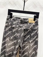 Black denim jeans with allover Balenciaga script print, front pockets and waistband label