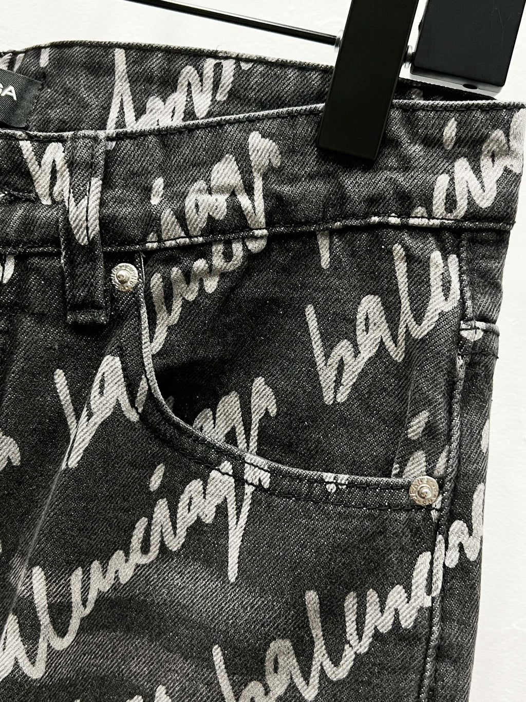 Black denim jeans with allover Balenciaga script print, pocket and button detail