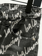 Black denim jeans with allover Balenciaga script print, pocket and button detail