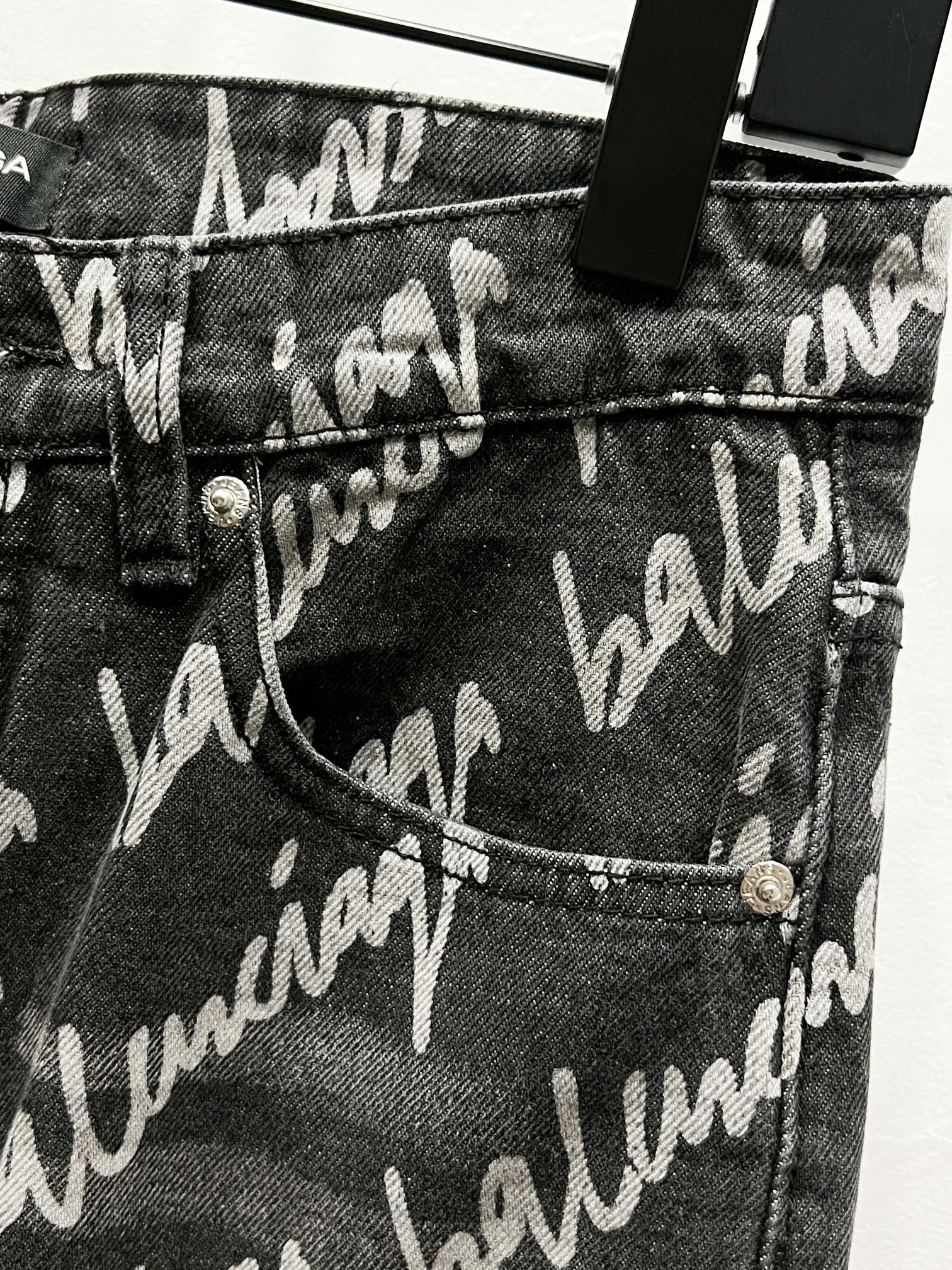 Black denim jeans with allover Balenciaga script print, pocket and button detail