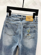 Light-wash denim pants, front view with pocket and tan brand patch