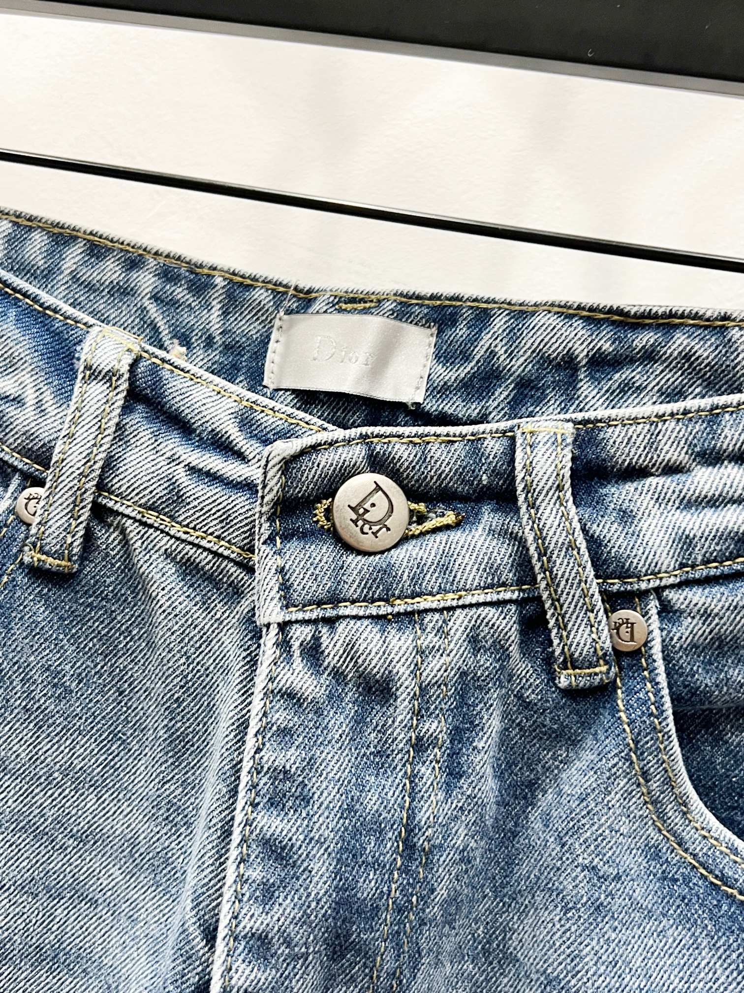 Light-wash denim pants with button, fly, and belt-loop hardware