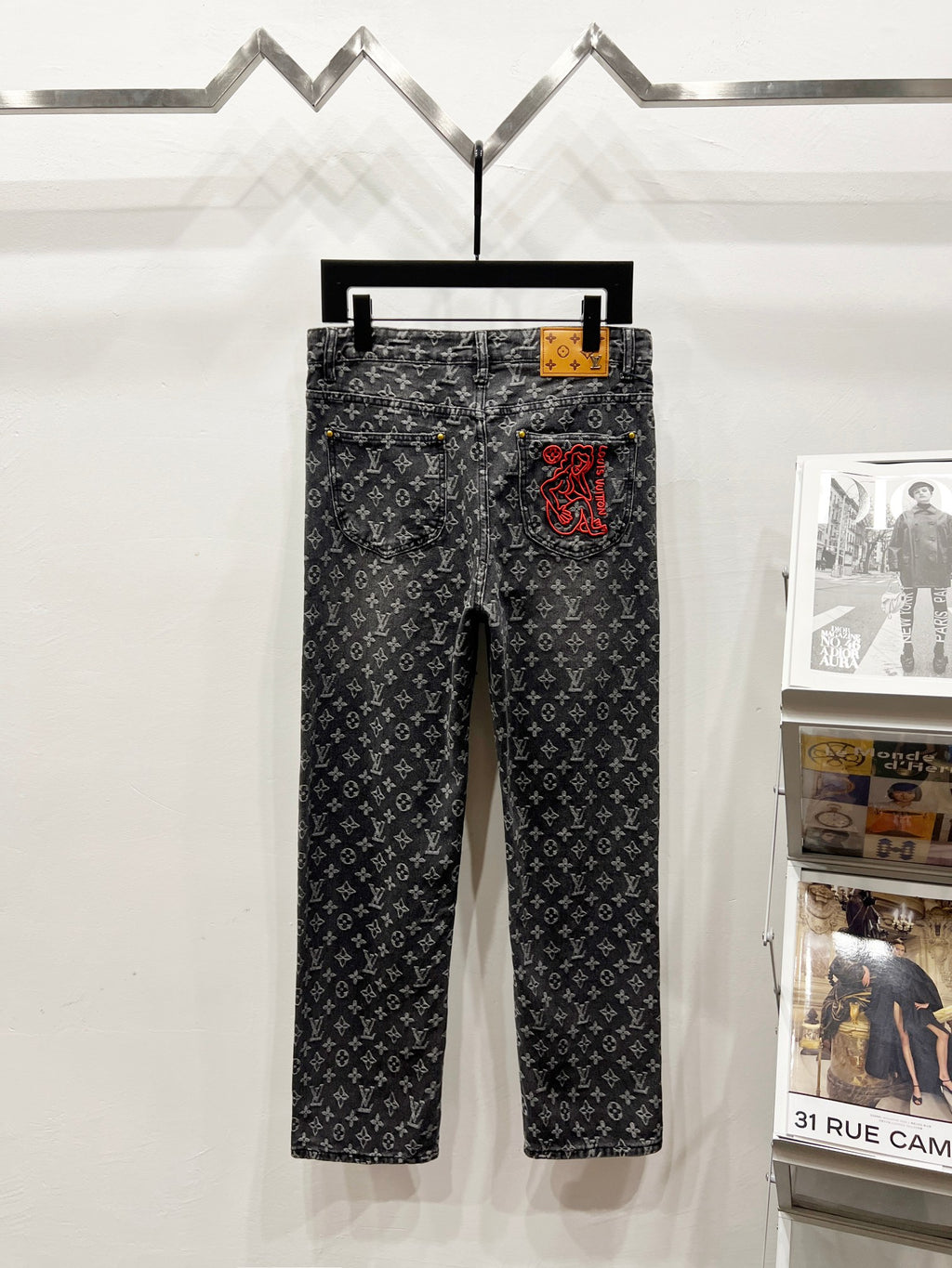 Louis Vuitton monogram dark jeans pants, back view with red logo patch