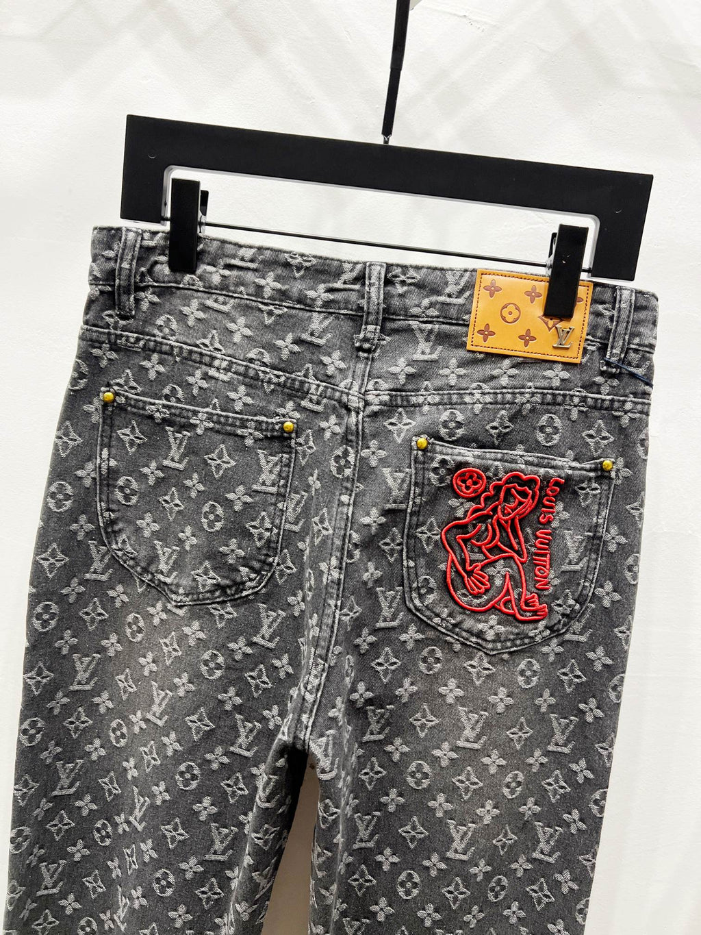 Louis Vuitton monogram jeans with belt loops and red logo side pocket