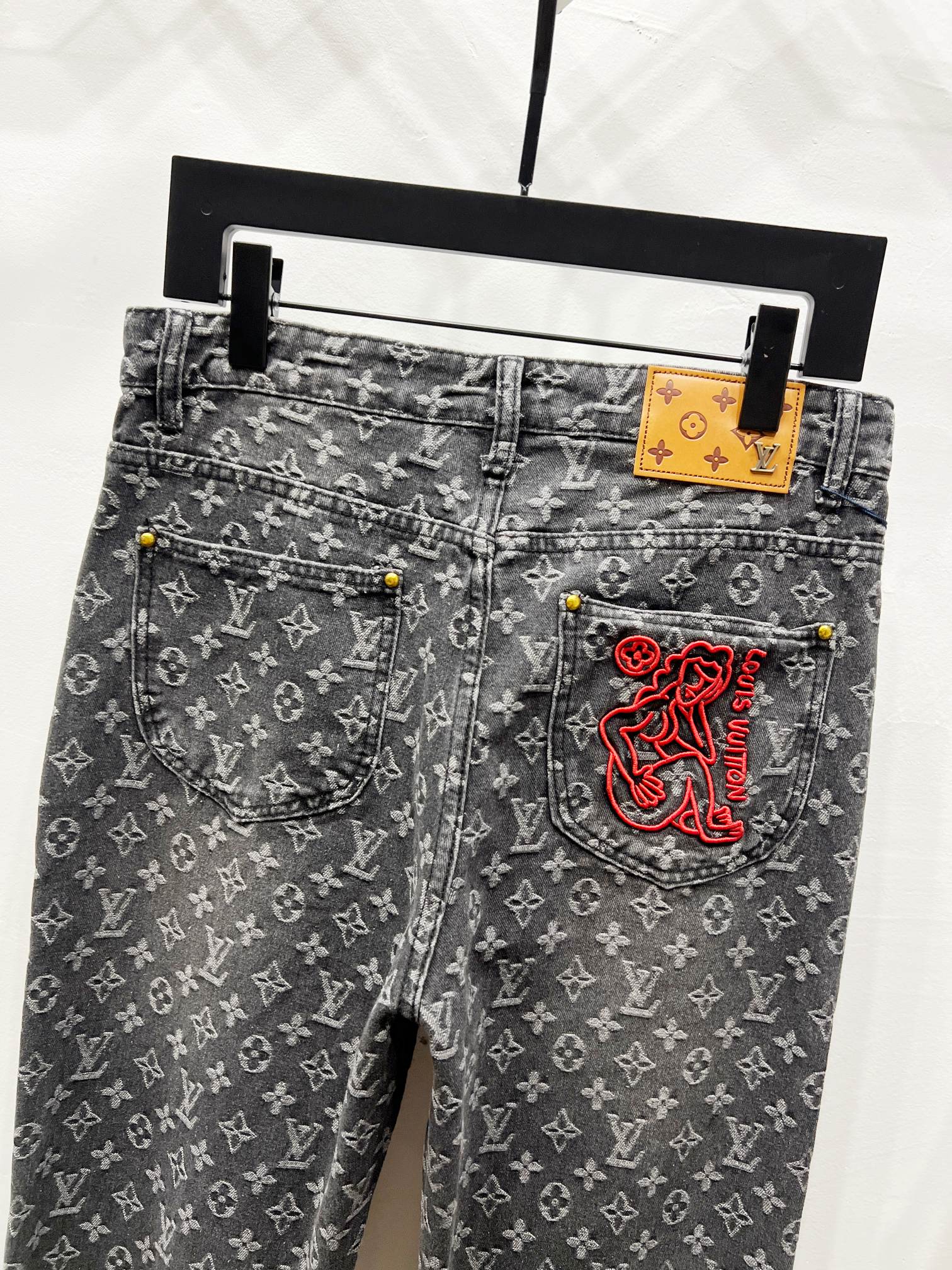 Louis Vuitton monogram jeans with belt loops and red logo side pocket