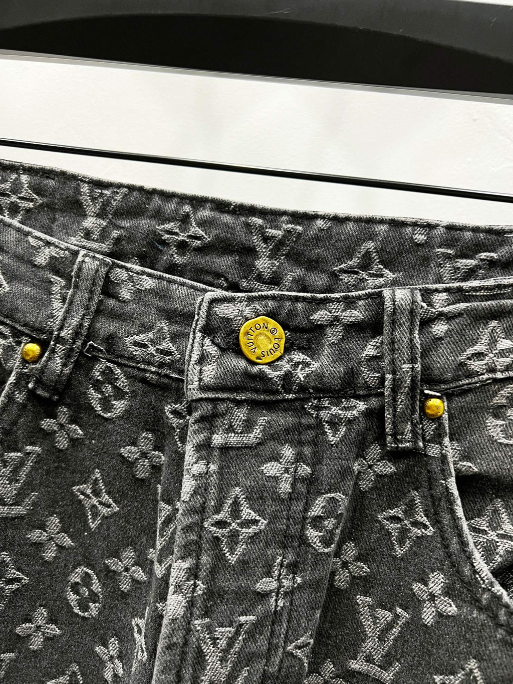 Louis Vuitton monogram denim jeans with yellow logo patch and button
