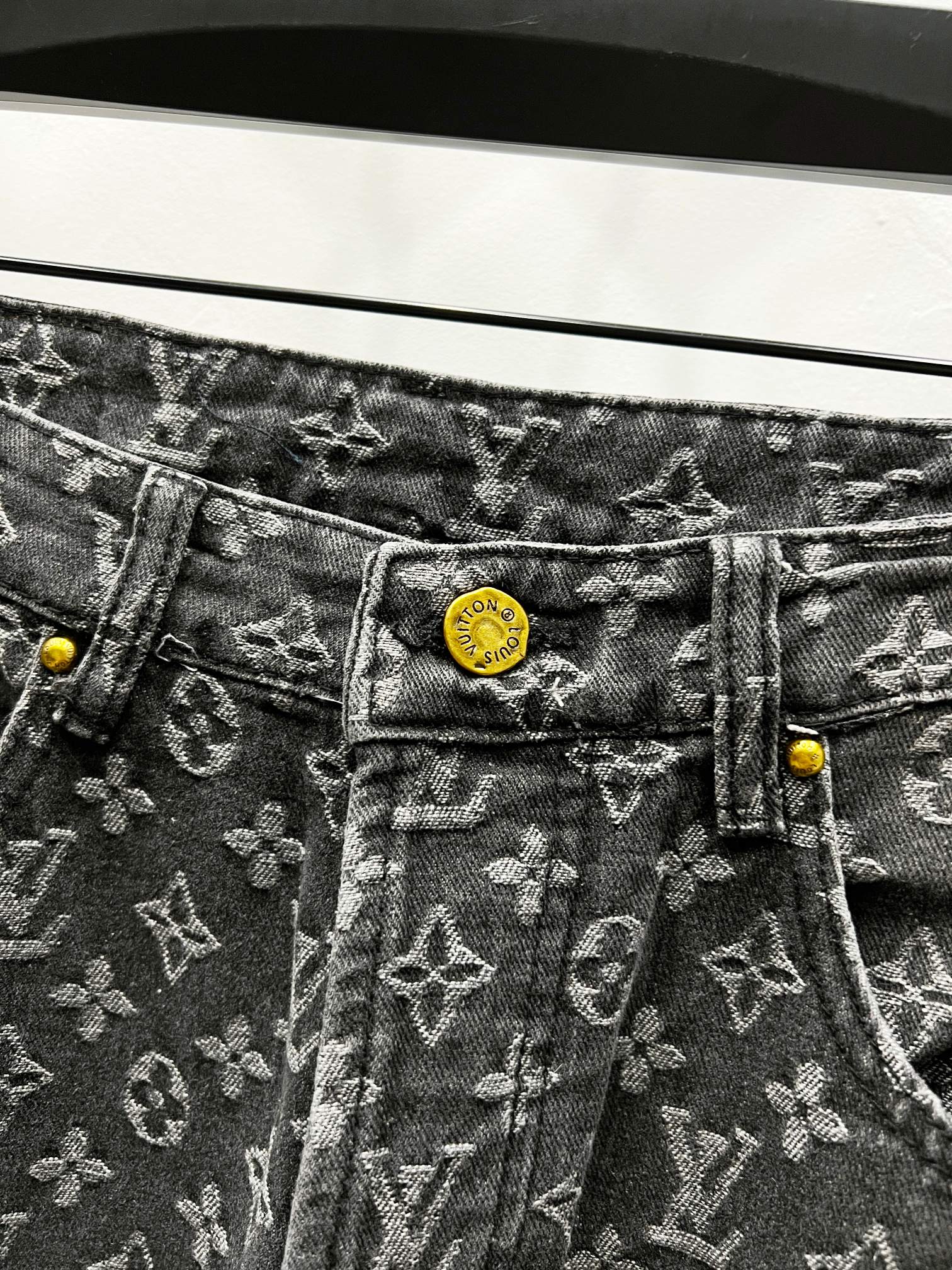 Louis Vuitton monogram denim jeans with yellow logo patch and button