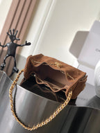 Tan-brown suede shoulder bag with open top and gold chain strap
