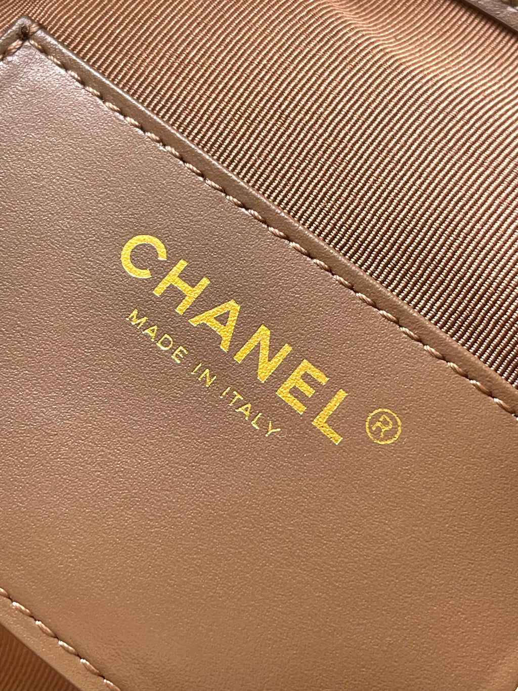 Chanel logo label and 'Made in Italy' on tan-brown suede bag
