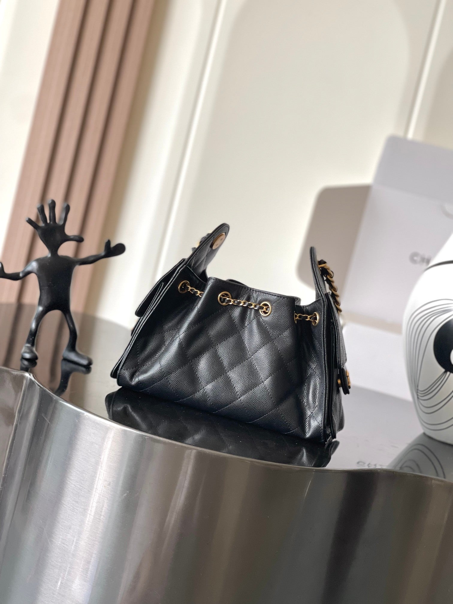 Black Chanel quilted shoulder bag with gold chain strap and front clasp